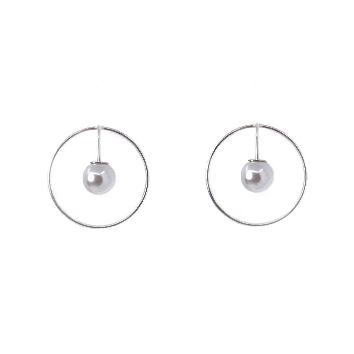 2. Studio image of Maarja Palu SPOT earrings featuring a pearl suspended in a silver circle