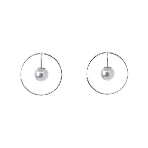 2. Studio image of Maarja Palu SPOT earrings featuring a pearl suspended in a silver circle
