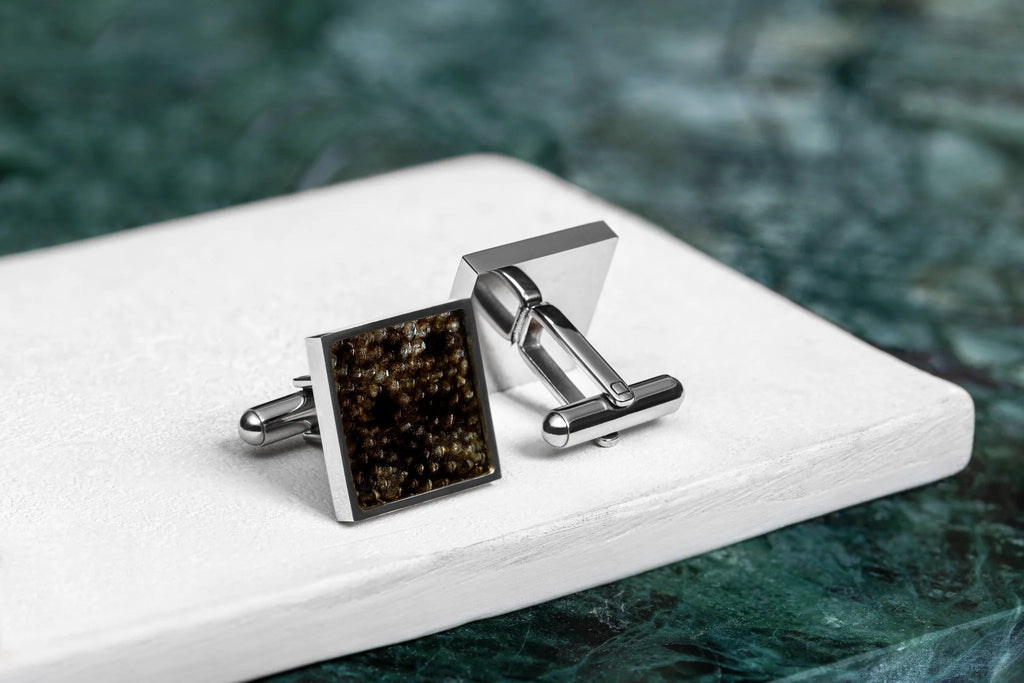 3. Pair of Eherüs square cufflinks made from dark brown trout leather on white and green marble surface