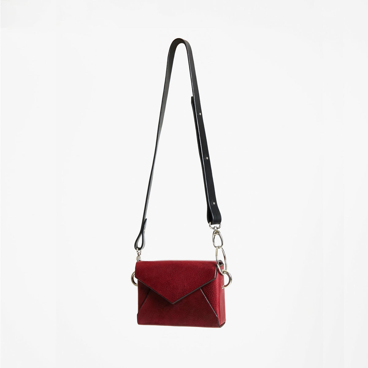 3. Studio image of Daz Studio handmade leather envelope bag in burgundy with adjustable strap and silver magnet closure