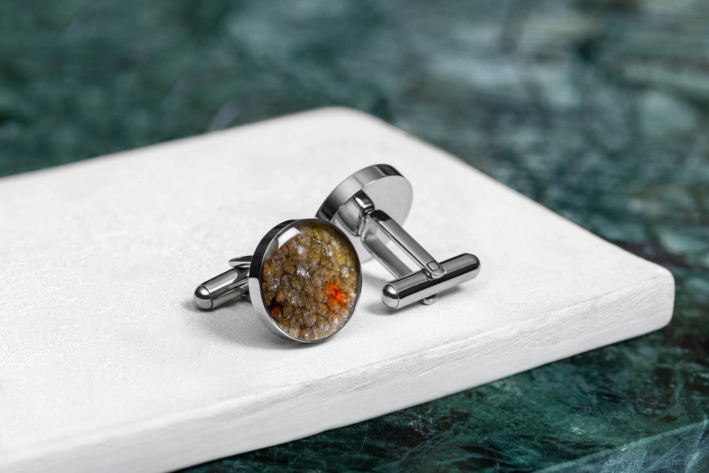 2. Pair of Eherüs round cufflinks with red-spotted brown trout leather on white surface