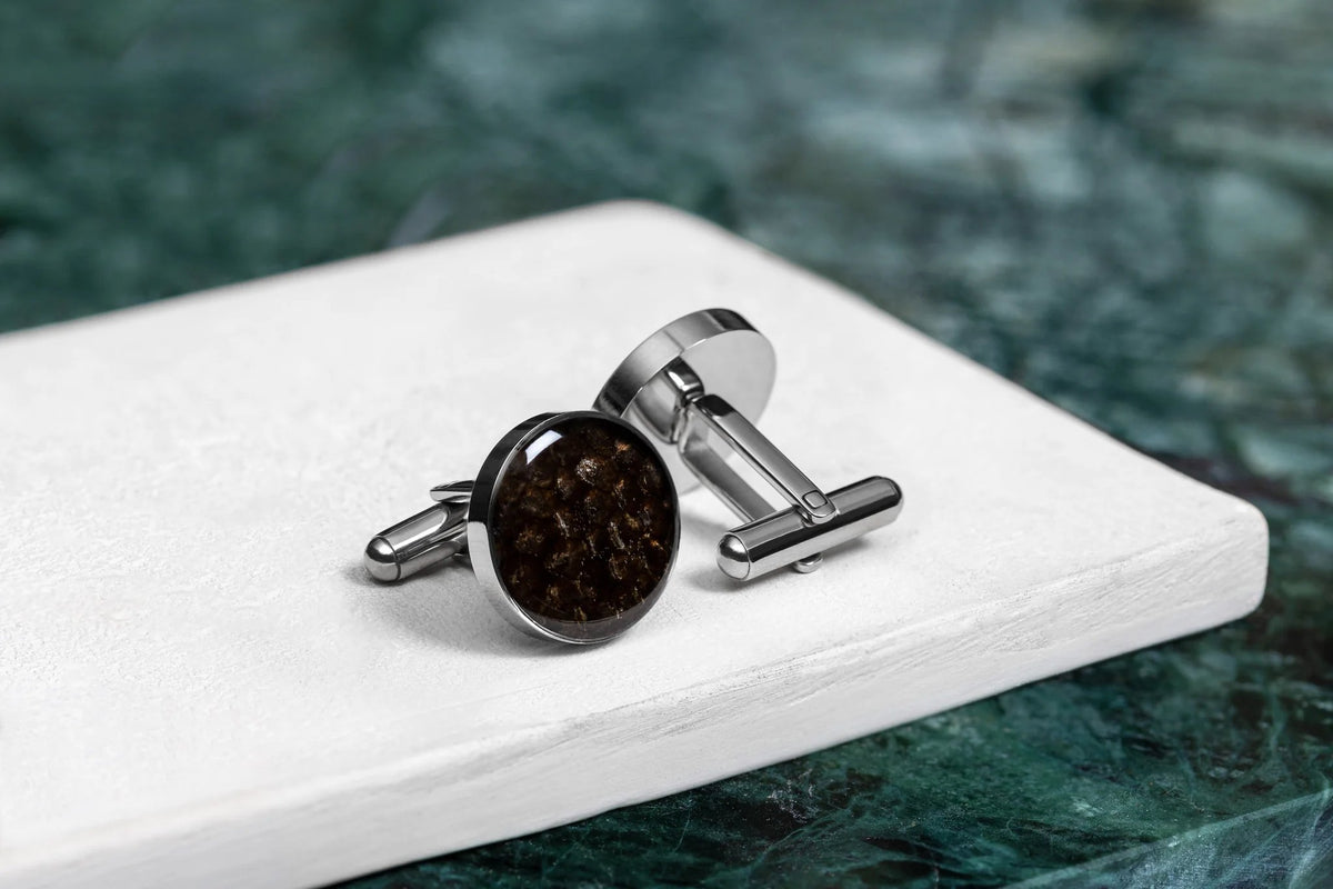 3. Studio shot of Eherüs round cufflinks made from brown trout leather on white surface