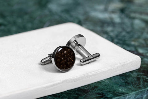 3. Studio shot of Eherüs round cufflinks made from brown trout leather on white surface