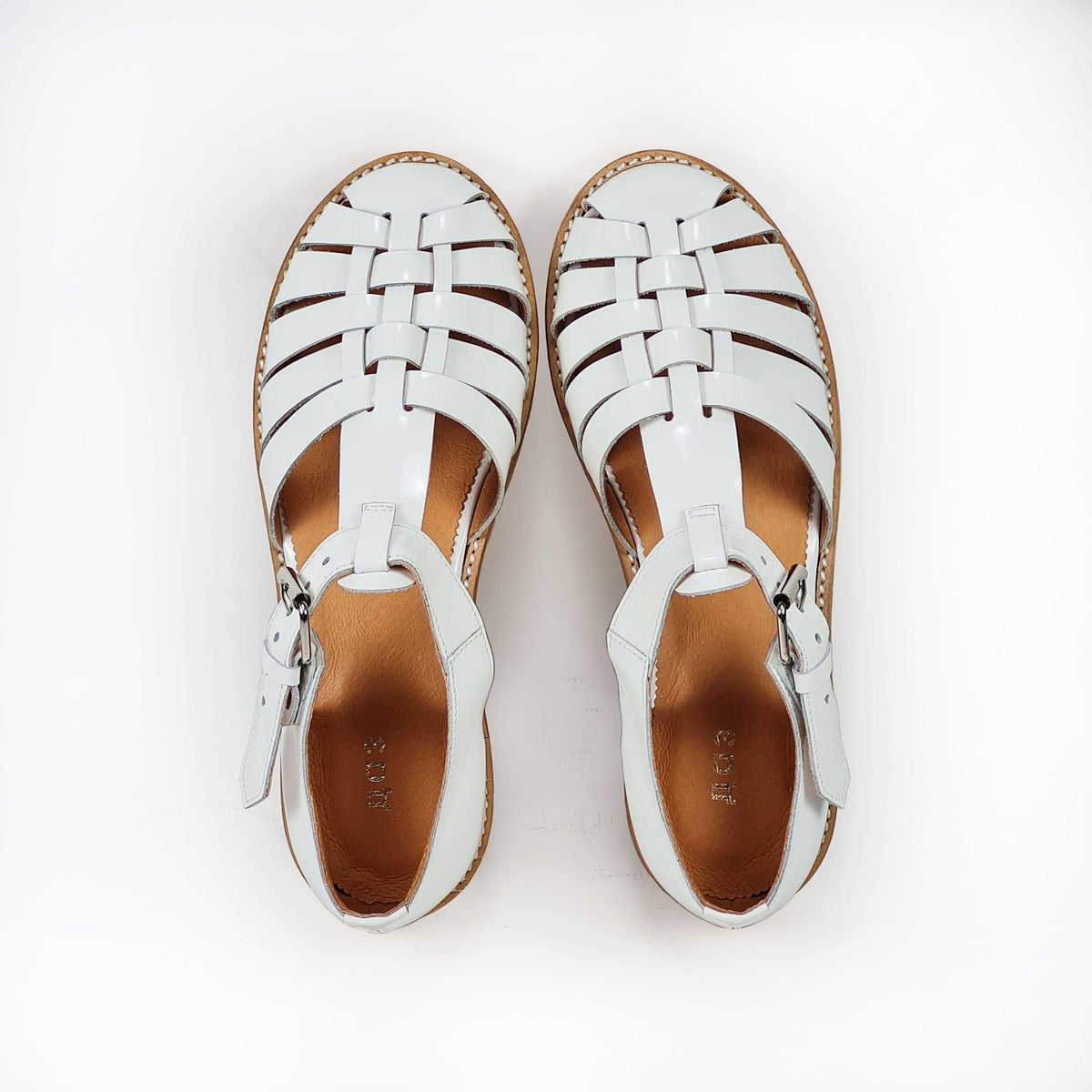 4. Top view of white leather fisherman sandals by Daz Studio, showcasing intricate strap design