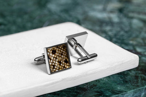 2. Eherüs square cufflinks made from black-spotted brown trout leather and stainless steel on white surface