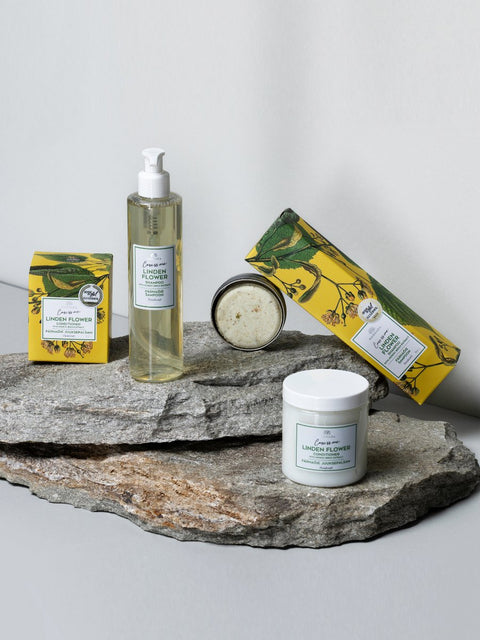 2. Woman holding Magrada Organic Cosmetics Solid Linden Flower Shampoo bar, highlighting product size and texture