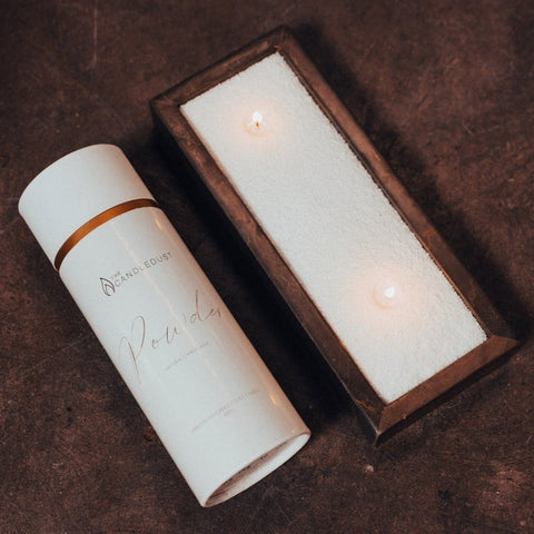 2. Candledust Breeze powdered candle next to lit candle in rectangular container, showcasing customizable eco-friendly design