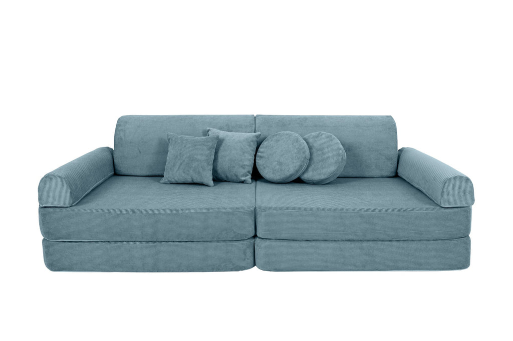 8. Turquoise corduroy children's sofa with cylindrical and square cushions, arranged as a traditional sofa with cushions in the center on a black background