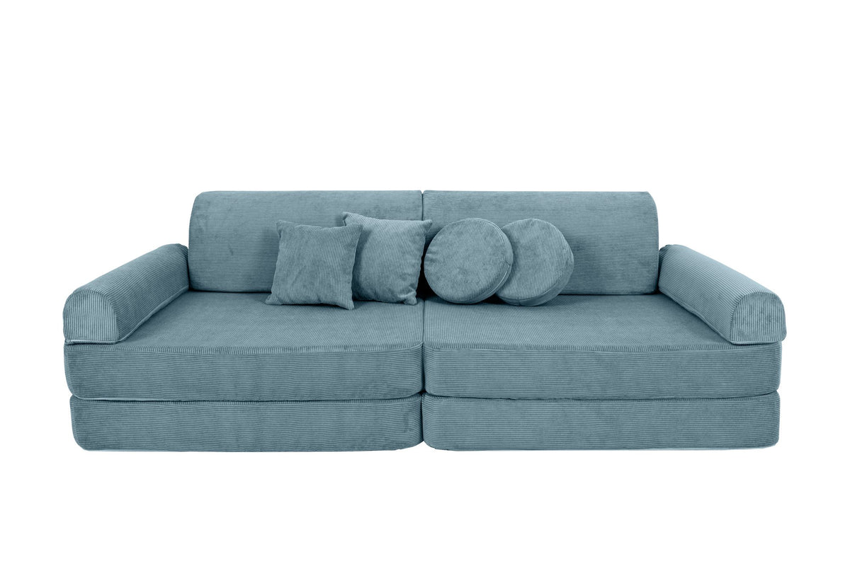 8. Turquoise corduroy children's sofa with cylindrical and square cushions, arranged as a traditional sofa with cushions in the center on a black background