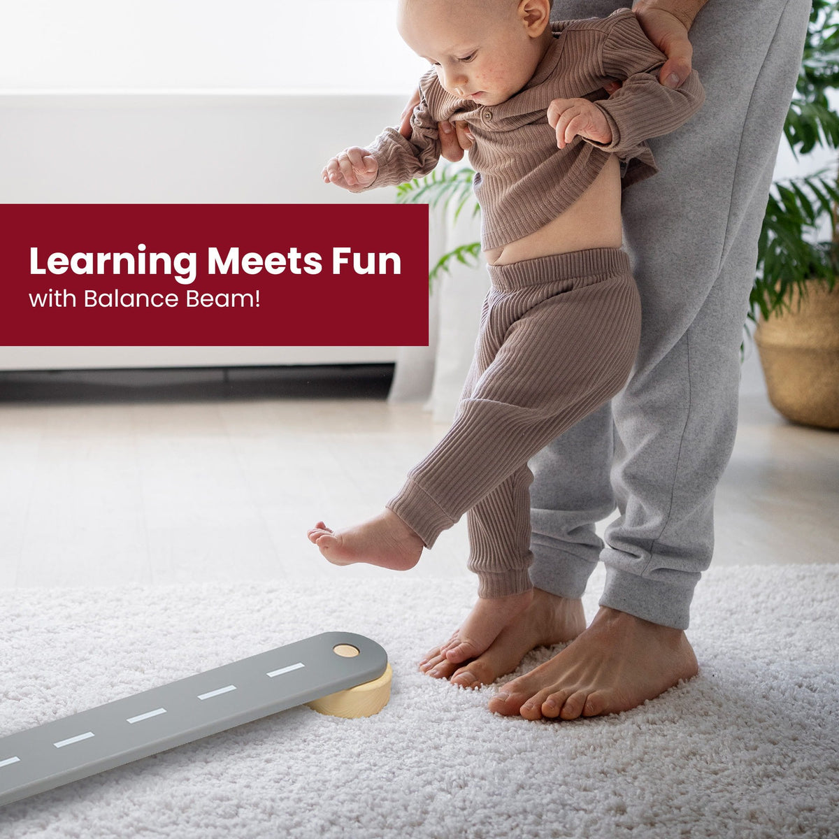 10. Parent assisting baby on grey road design wooden beam with text 'Learning Meets Fun'