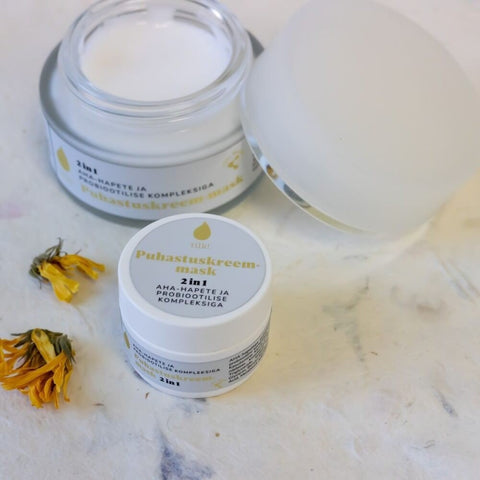 2. Open jar of Tilk! 2-in-1 Cleansing Cream-Mask with 10% AHA acids, featuring product label and floral decoration