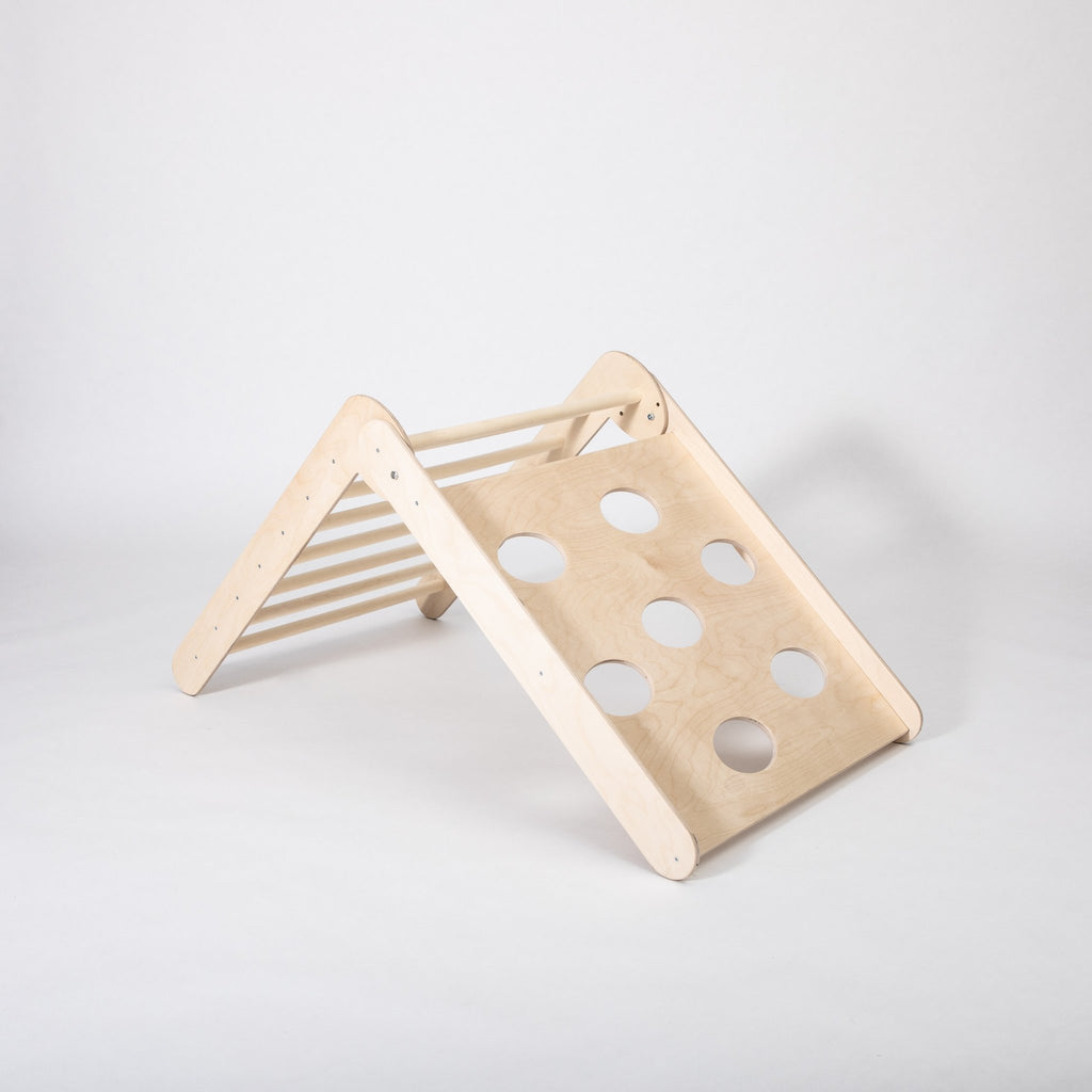 2. Studio shot of Montessori climbing triangle with circular cutouts on white background