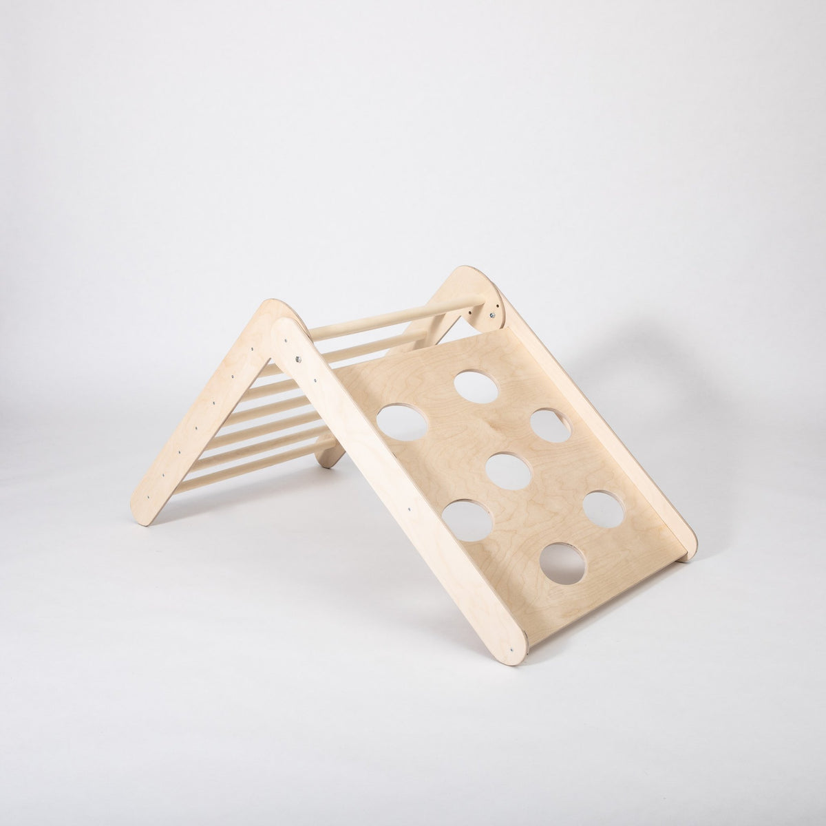 2. Studio shot of Montessori climbing triangle with circular cutouts on white background