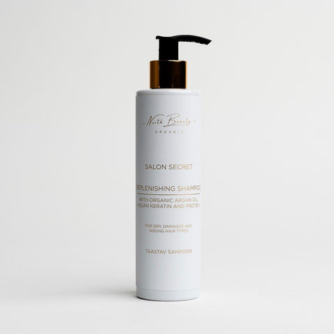 3. North Beauty replenishing shampoo bottle with gold pump on white background, featuring product label and details