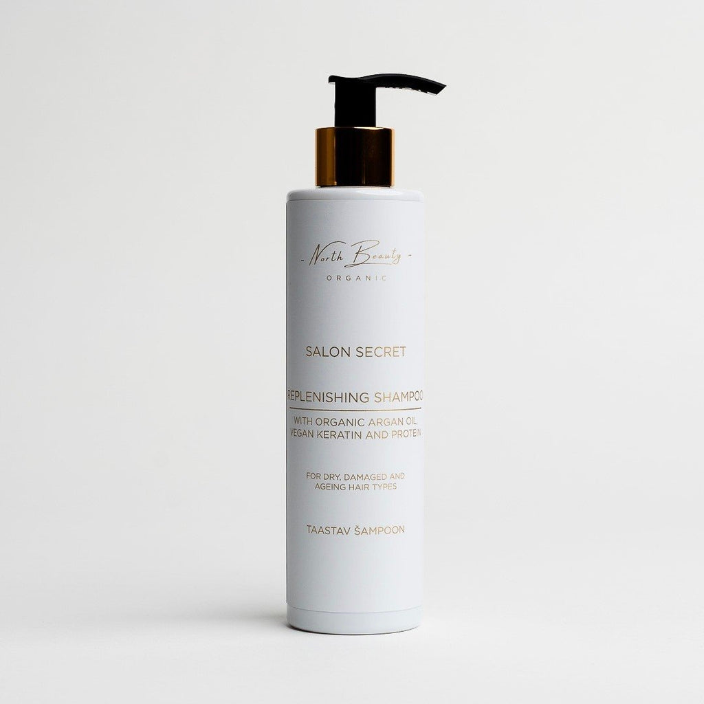 2. North Beauty Salon Secret Replenishing Shampoo with organic argan oil and vegan keratin in white bottle with gold pump on white background
