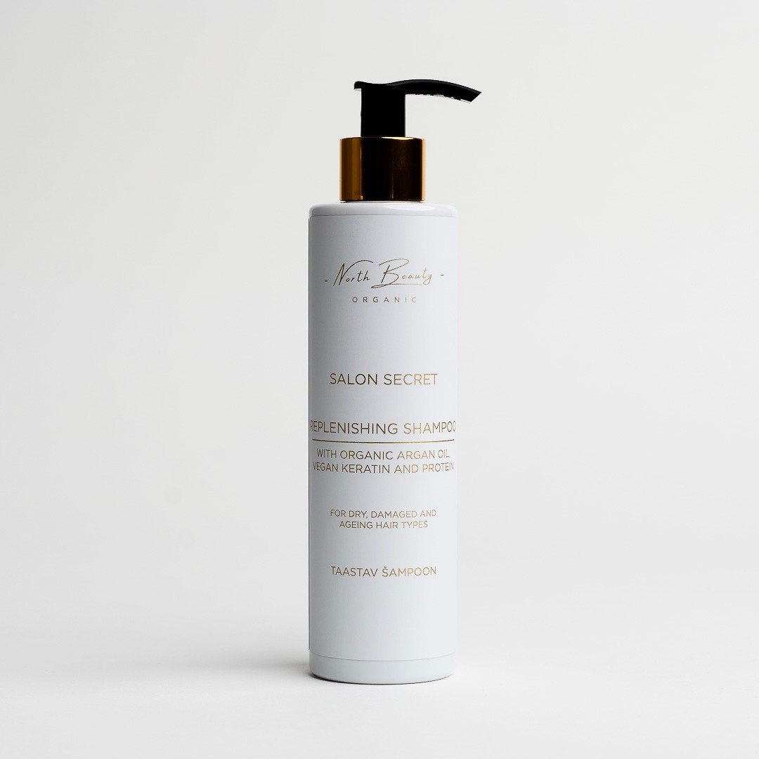 2. North Beauty Salon Secret Replenishing Shampoo with organic argan oil and vegan keratin in white bottle with gold pump on white background