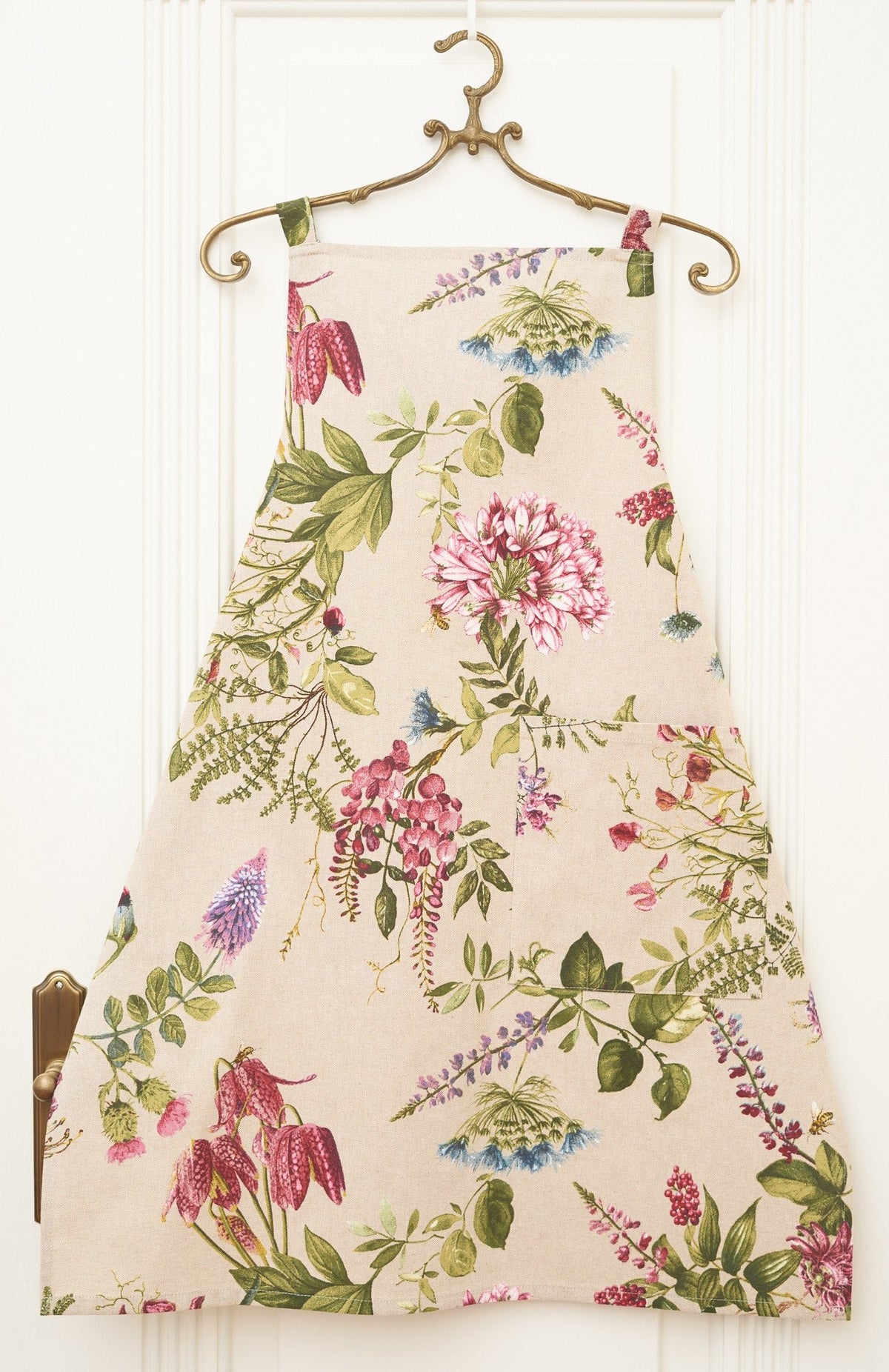 3. Studio shot of Hortensias Home Ladies' Apron Simple - Botanico with vibrant floral print on hanger