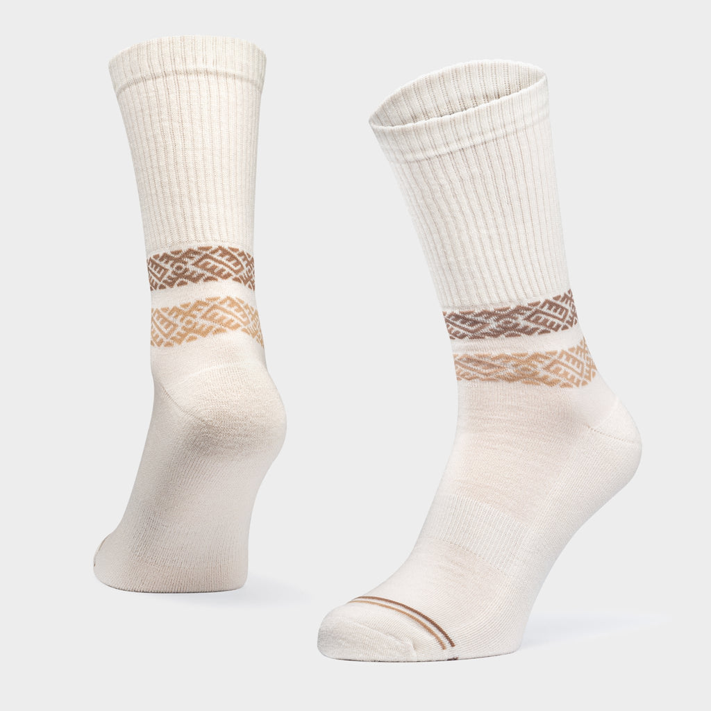 3. Studio shot of Baltland unisex merino wool socks in white with brown pattern, highlighting ribbed cuff and arch support