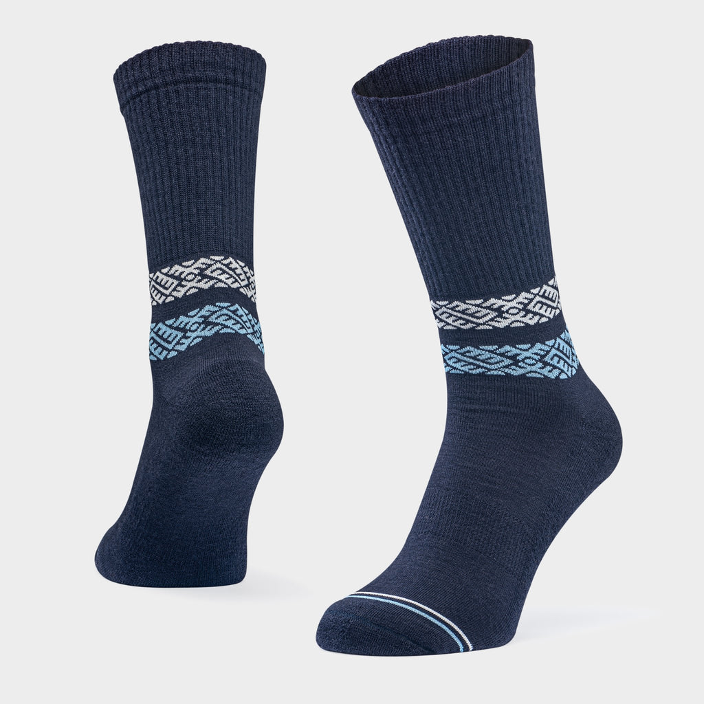 2. Studio shot of Baltland unisex merino wool socks in blue with white and blue pattern, showing ribbed cuff and seamless toe