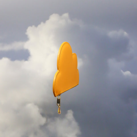 3. Angled view of Tairi Roosve mustard Leather Cloud Purse highlighting its sleek design and sustainable leather material