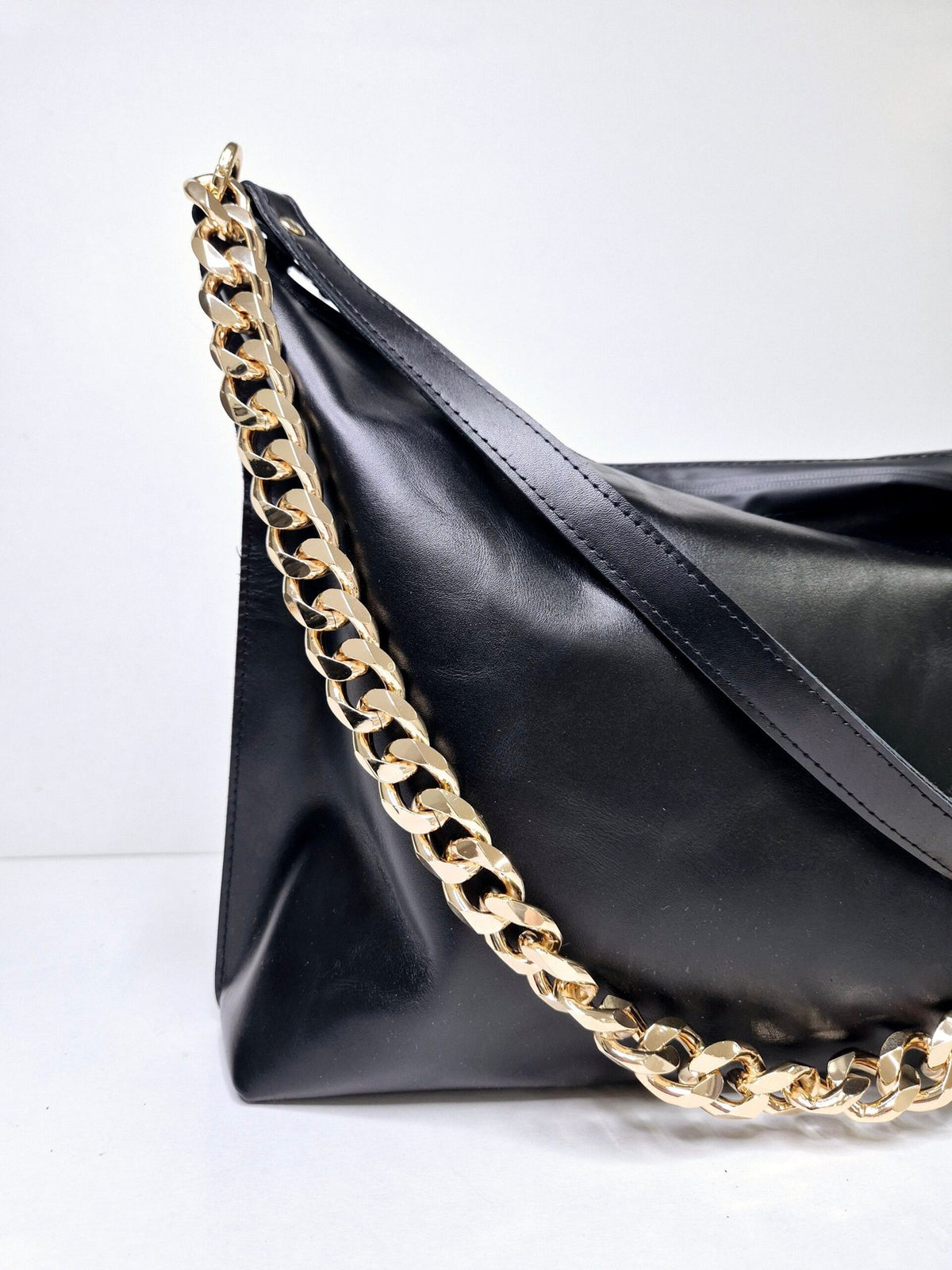 6. Close-up of Zelma Kraft black leather hobo bag with gold chain detail