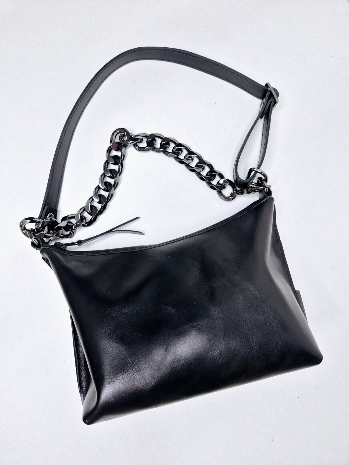 6. Studio image of Zelma Kraft black leather hobo bag with silver chain and detachable strap