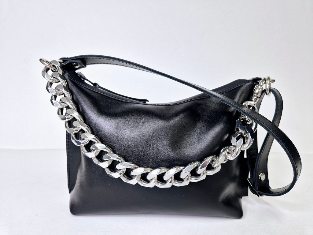 7. Close-up of Zelma Kraft black leather hobo bag interior with gold chain and zippered pocket