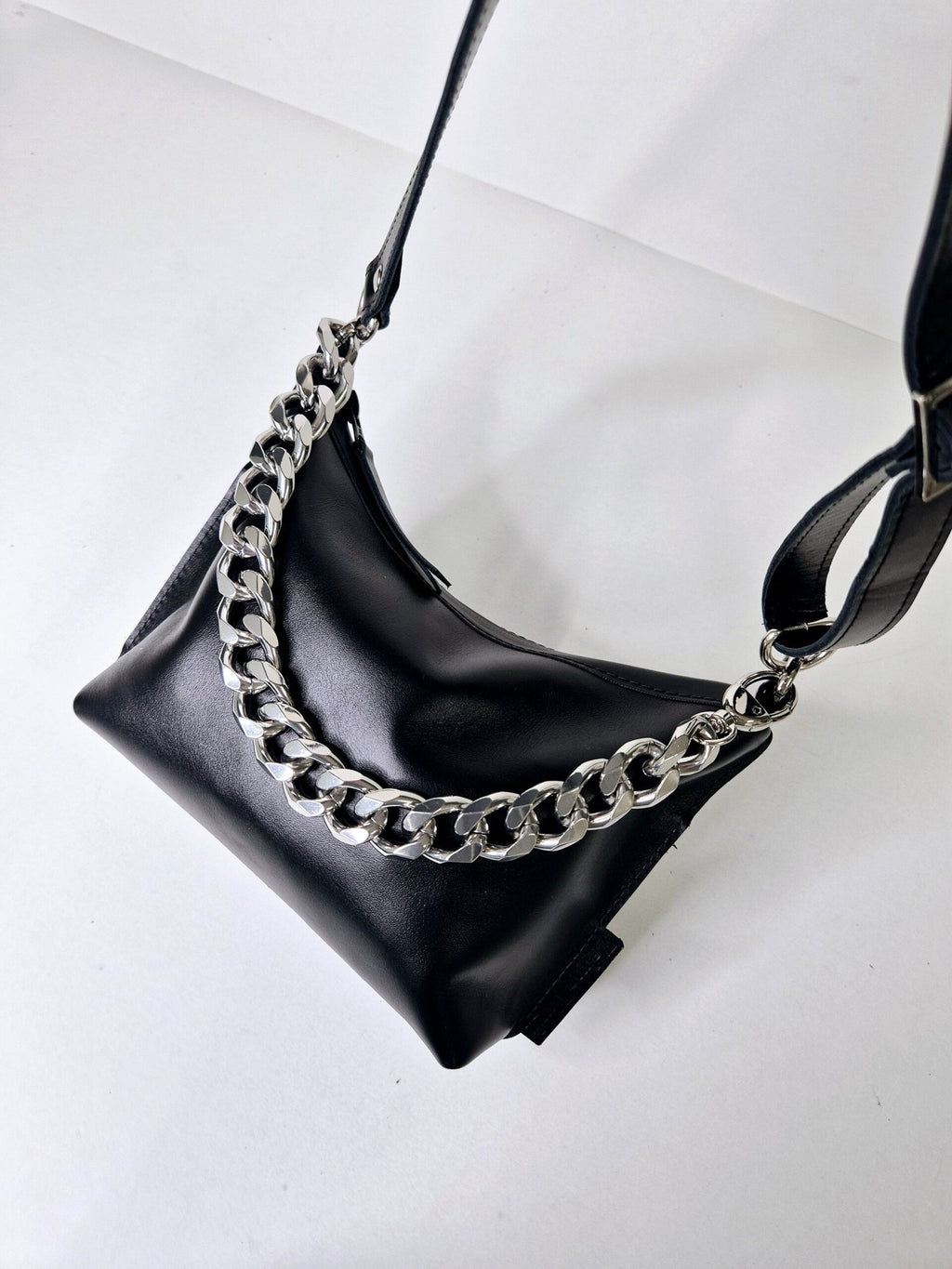 5. Studio shot of Zelma Kraft black leather hobo bag with silver chain and adjustable strap