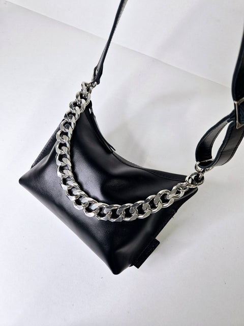 5. Studio shot of Zelma Kraft black leather hobo bag with silver chain and adjustable strap