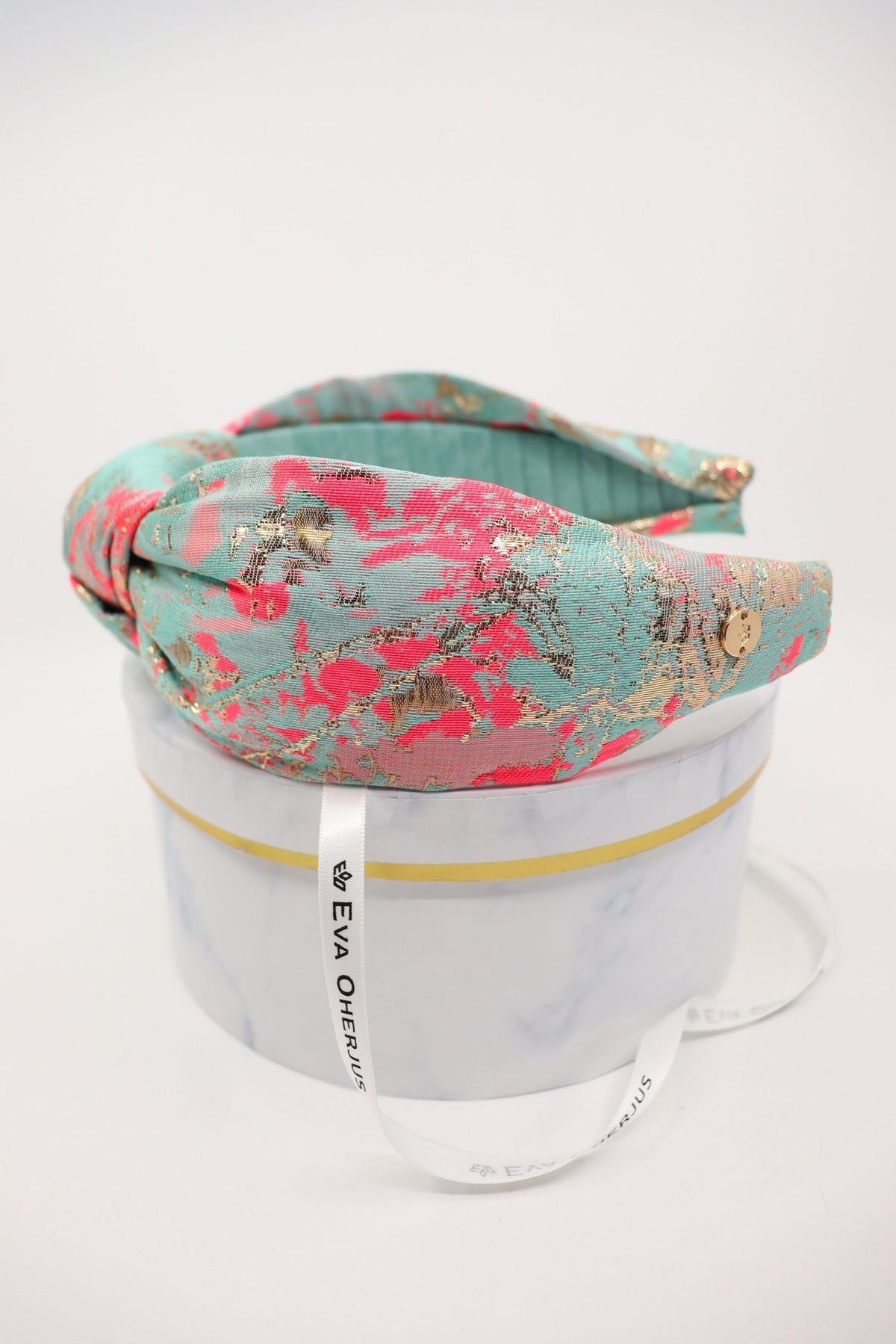 4. Side view of Eva Oherjus Knot Headband Misty highlighting unique abstract design and golden logo tag