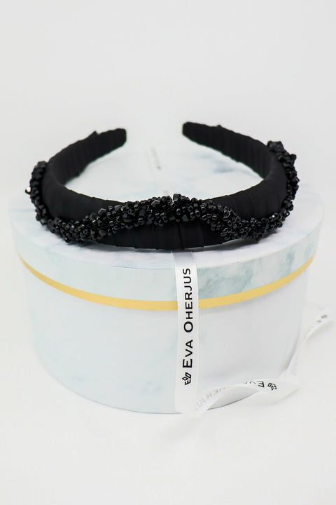 3. Studio shot of Eva Oherjus Beaded Thin Mulberry Silk Headband Hestia on marble hat box