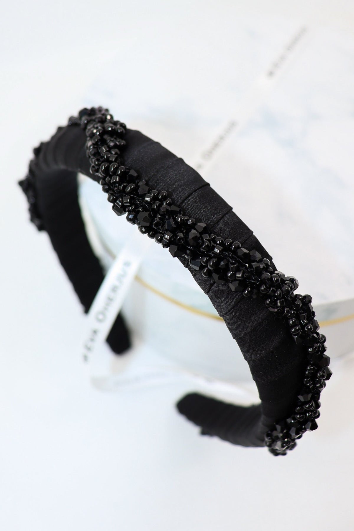 2. Close-up of Eva Oherjus Beaded Thin Mulberry Silk Headband Hestia with black shiny beads