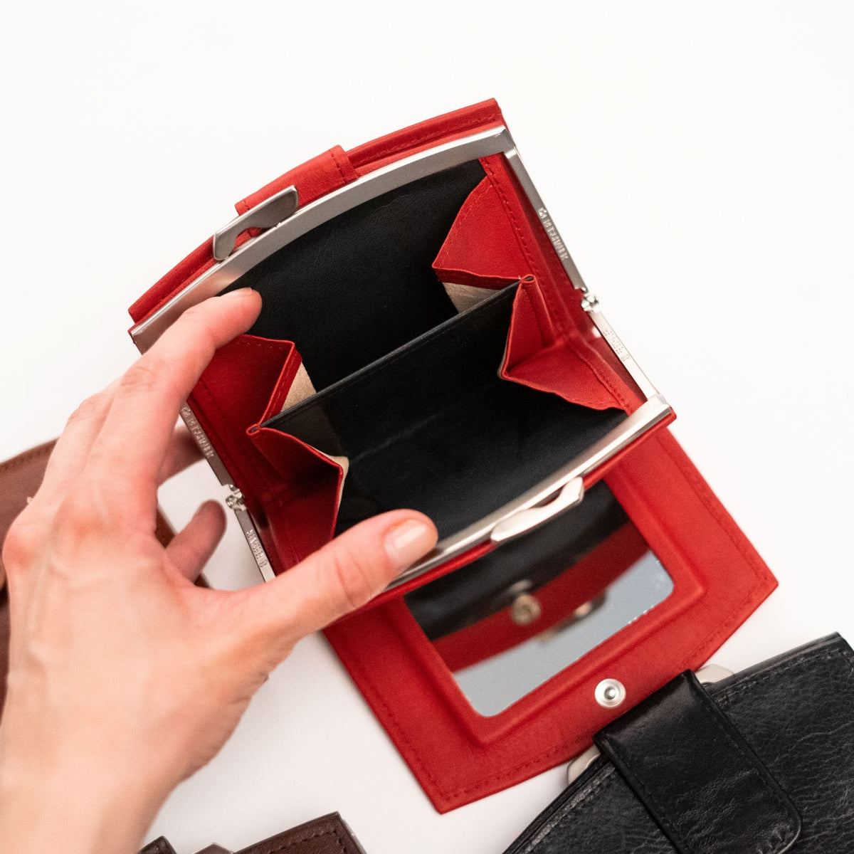 3. Close-up of Papillon women's red leather wallet with open coin pocket and mirror, highlighting interior design