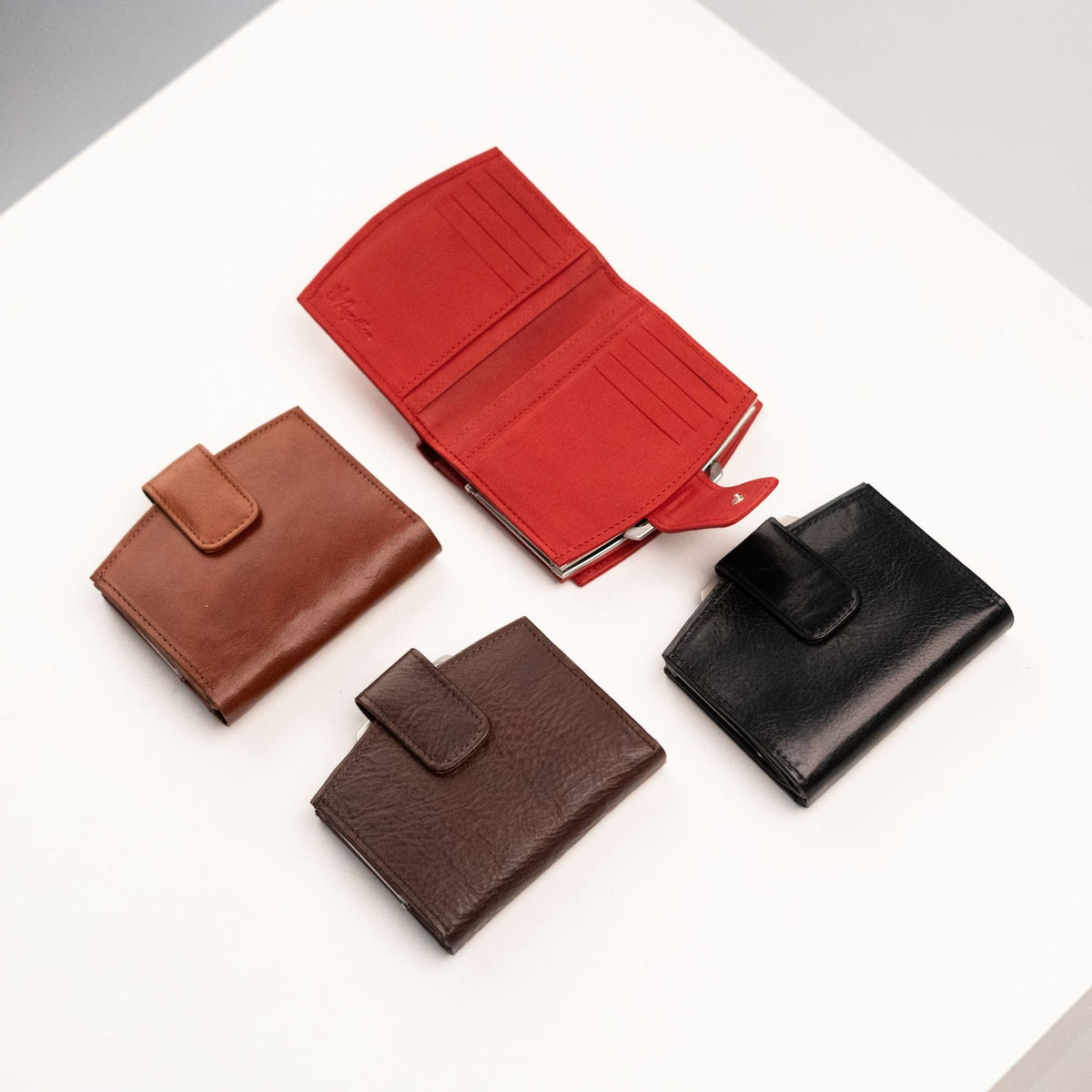 5. Open view of Papillon women's red leather wallet, displaying card slots and interior compartments, with other colors closed