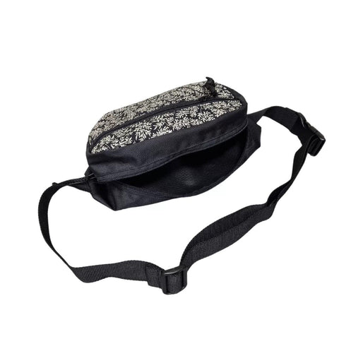 3. Side view of Drinbags FERN dog treat bag with adjustable strap, black with floral design