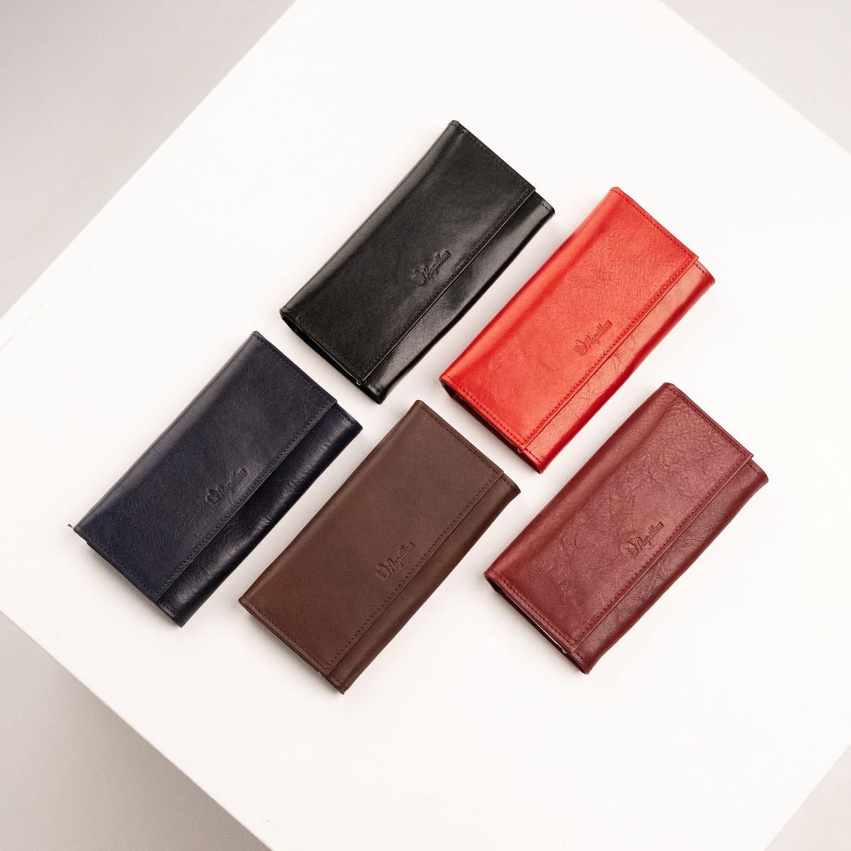 5. Collection of Papillon leather wallets in black, red, dark brown, dark blue, and Bordeaux, shown closed