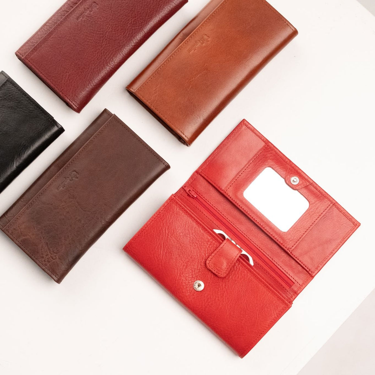4. Women's red leather wallet by Papillon with mirror, shown open with various color options