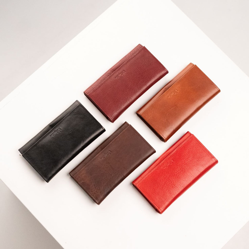 8. Assorted Papillon leather wallets in black, red, cognac, dark brown, and Bordeaux, shown closed