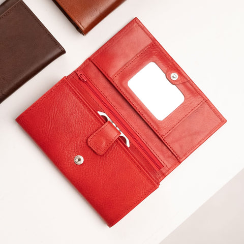 1. Women's red leather wallet by Papillon with mirror and card slots, shown open with brown and black wallets in background
