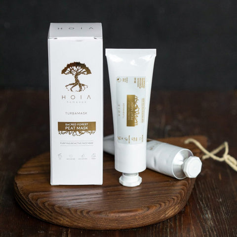4. HOIA homespa Sacred Forest Peat Mask tube and box on wooden surface, highlighting product packaging and design