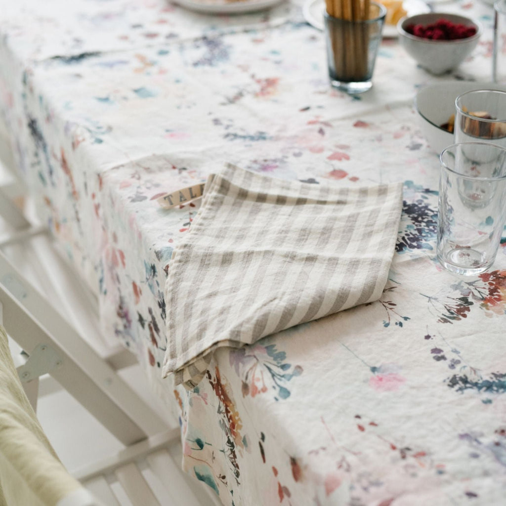3. Striped linen kitchen towel on floral tablecloth with glassware
