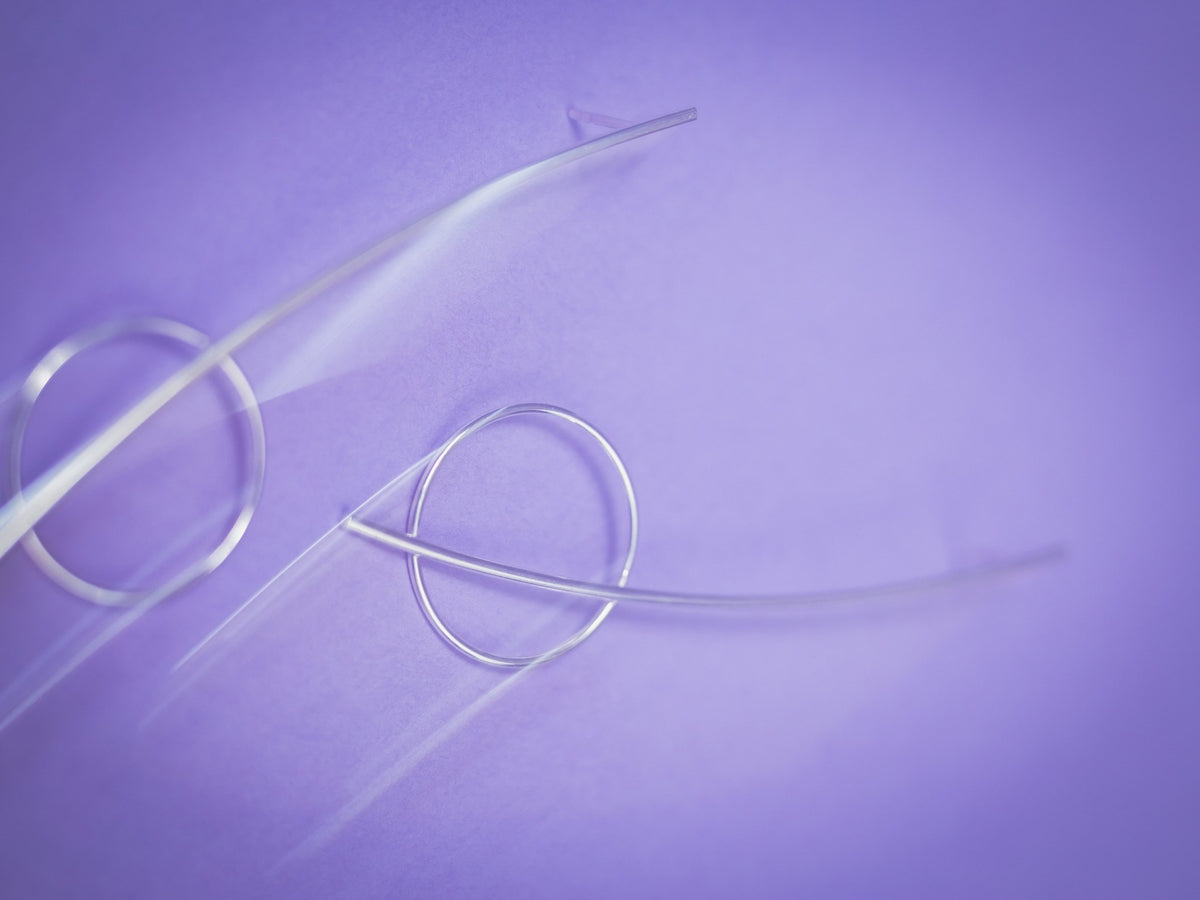 3. Close-up of Maarja Palu HARMONY silver earrings on purple background, highlighting modern minimalist design