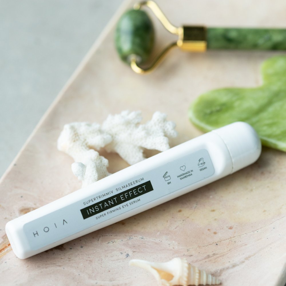 1. HOIA homespa Superfirming Eye Serum Instant Effect 10ml on marble surface with jade roller and coral