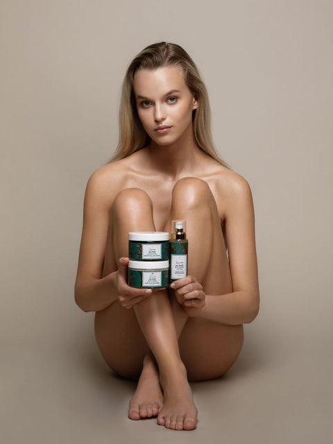 1. Woman holding Magrada Organic Cosmetics Firming Set for Body, featuring algae body mask, serum, and cream