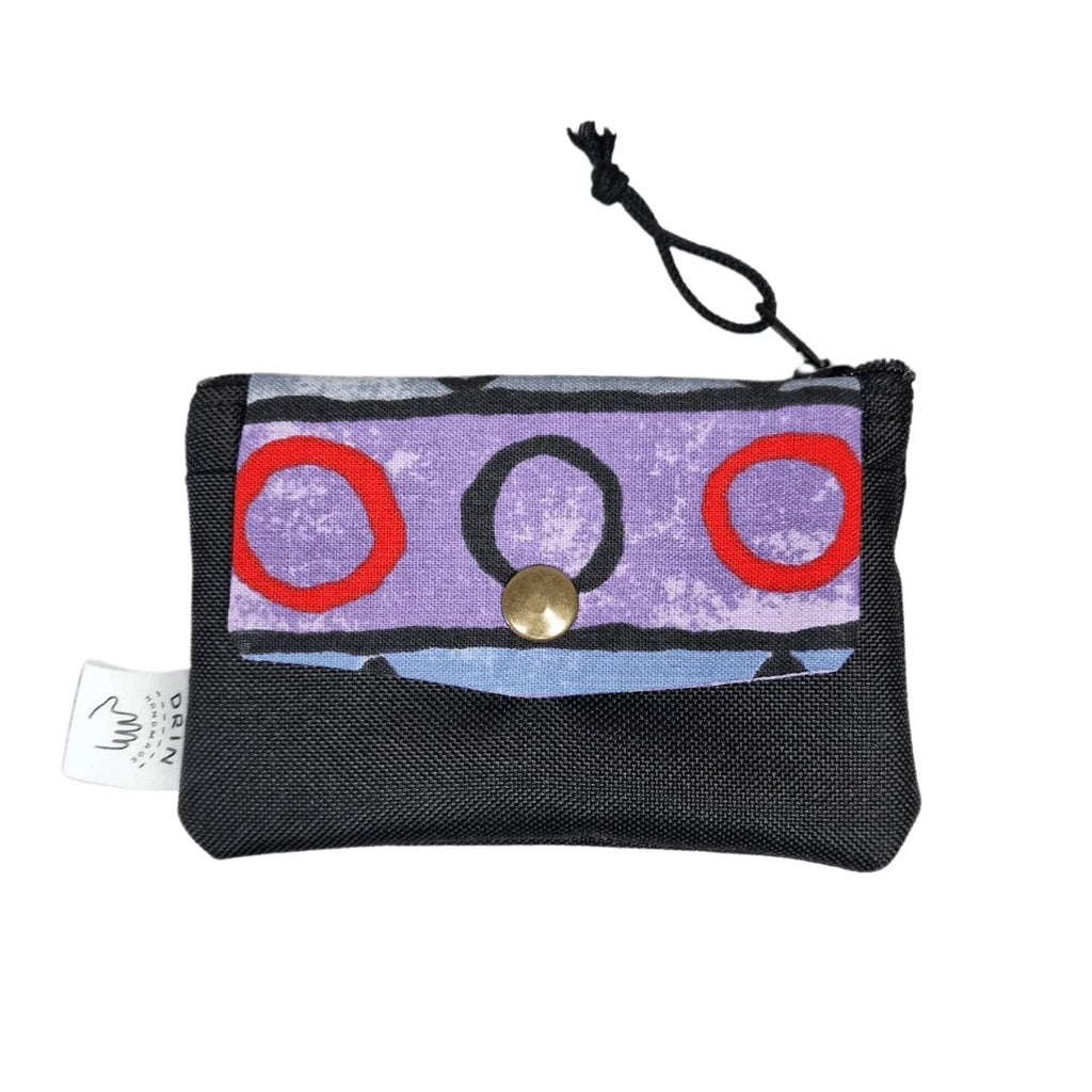 1. Drinbags ZIG ZAG wallet in vibrant reused fabric with purple and red design, featuring a secure metal press button and zipper closure, shown in studio
