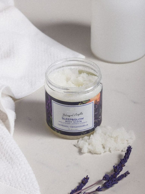 3. Open jar of Magrada Organic Cosmetics Lavender Body Scrub with Grapefruit Essential Oil on marble surface with lavender sprigs