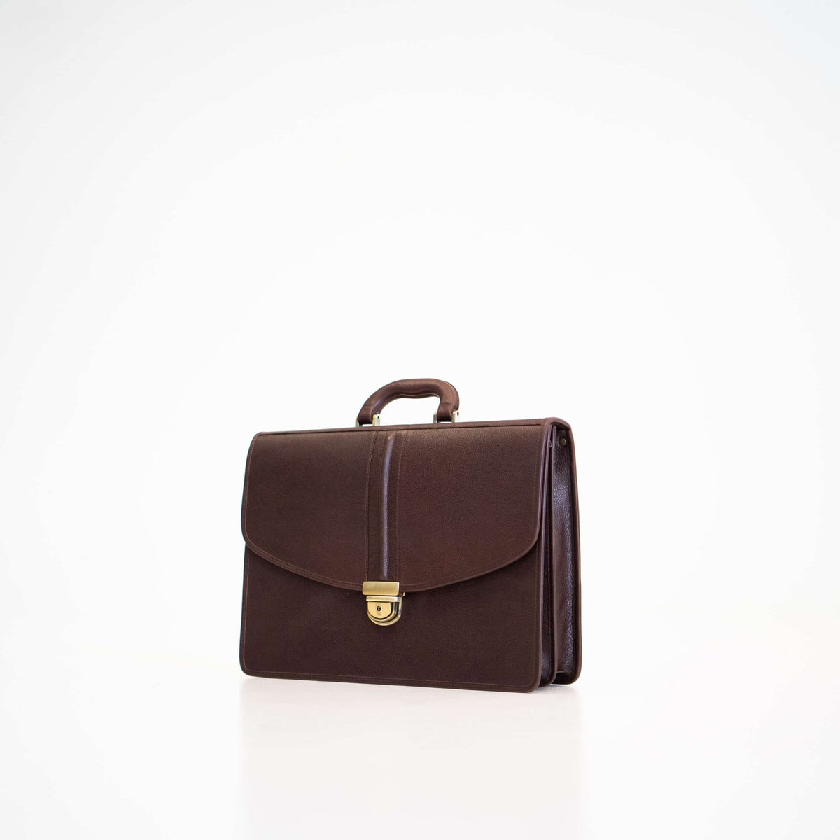 1. Papillon Leather Briefcase No. 99 in dark brown, angled front view, showcasing genuine leather and gold clasp