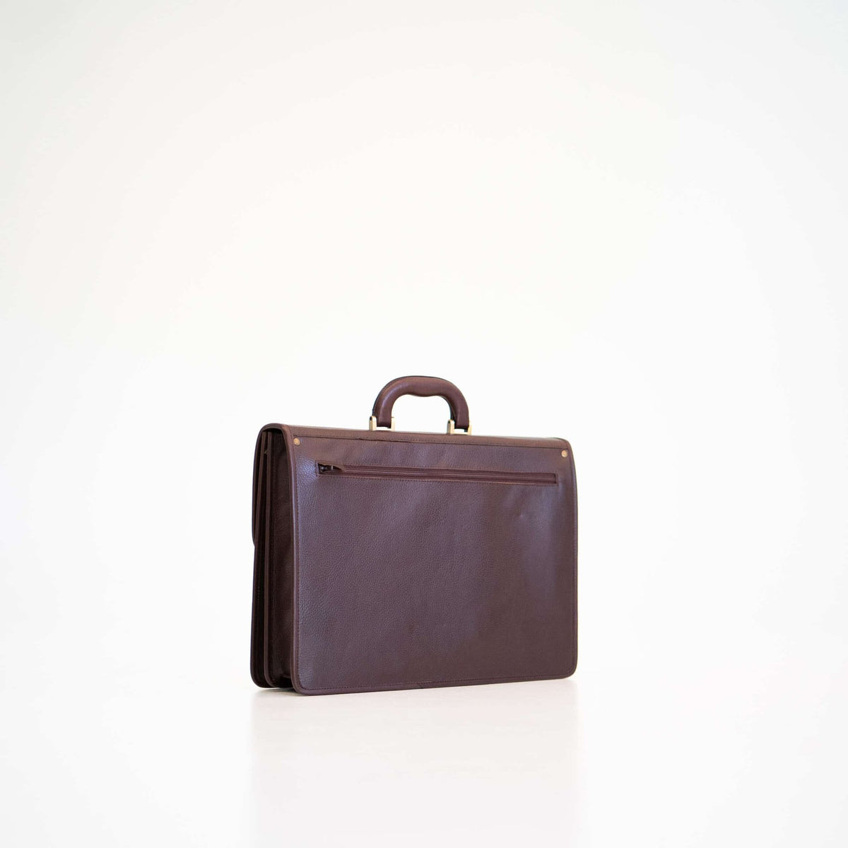 3. Side view of Papillon Leather Briefcase No. 99 in dark brown, highlighting sleek design and back pocket