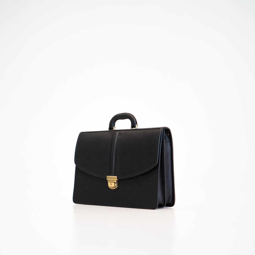 2. Studio shot of Papillon Leather Briefcase No. 99 in black, showing front view with gold clasp