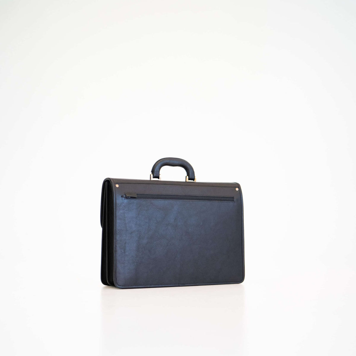 3. Studio shot of Papillon Leather Briefcase No. 99 in black, showing back view with zip pocket